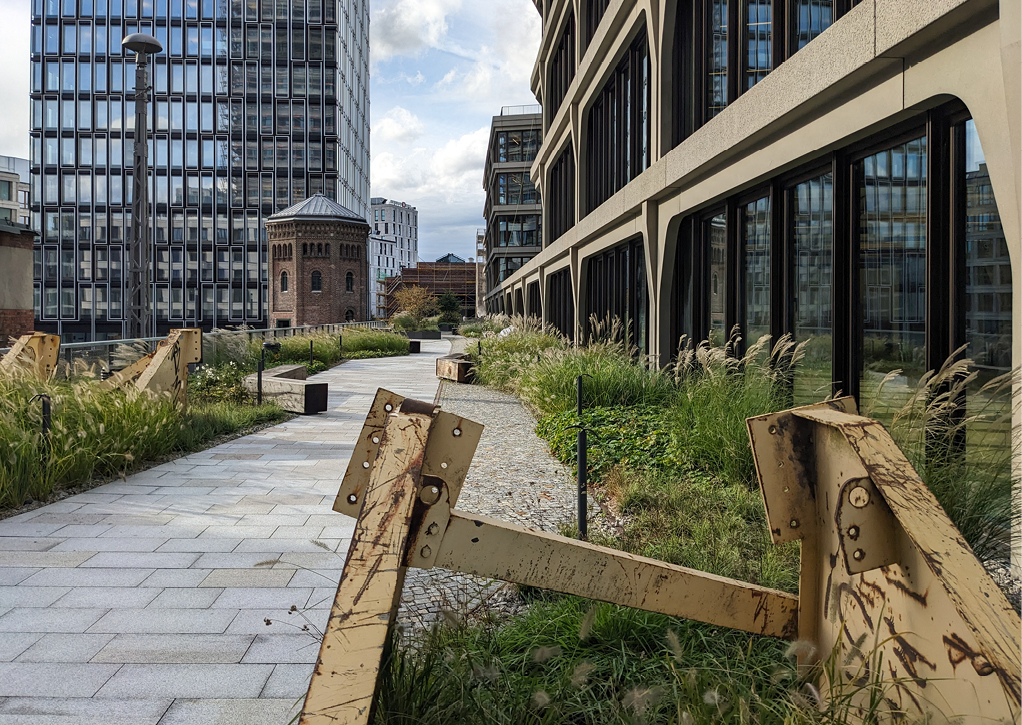 Bild 1 Grüne Wege zwischen moderner Architektur und historischem Mauerwerk: Die intensiv begrünten Dachflächen am Postbahnhof verbinden Aufenthaltsqualität mit wirksamem Regenwassermanagement. (Quelle: Levin Monsigny Landschaftsarchitekten)